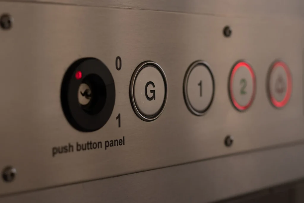A close up of buttons on a floor loading dumbwaiter, or trolley lift