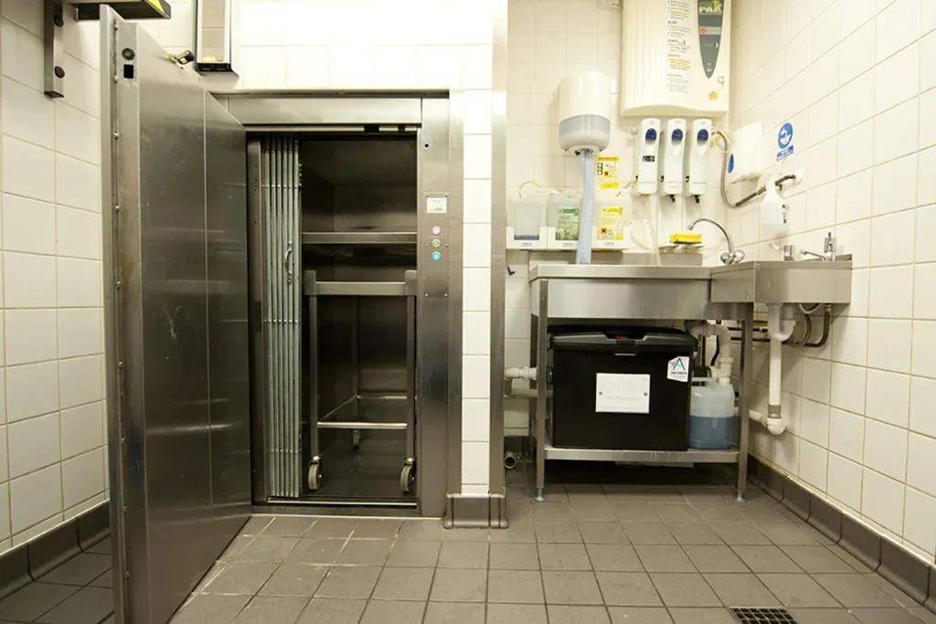 Floor loading dumbwaiter, or often called a trolley lift, installed in a restaurant